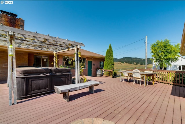 wooden terrace featuring a pergola and a hot tub