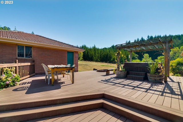 deck featuring a pergola and a hot tub