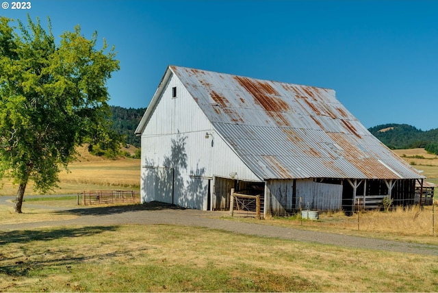 view of stable with a lawn and an outdoor structure