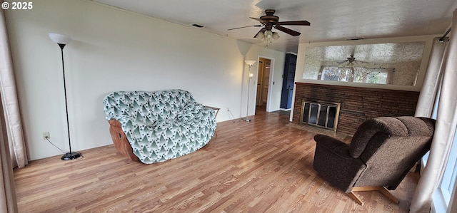 29545 Bailor St, Gold Beach, OR 97444 - sitting room with wood finished floors, a ceiling fan, and a fireplace