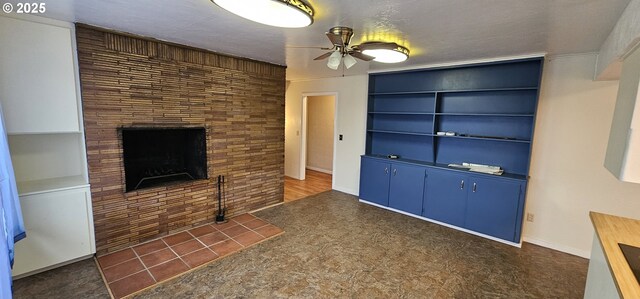 29545 Bailor St, Gold Beach, OR 97444 - unfurnished living room with ceiling fan, built in features, and a fireplace