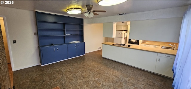 29545 Bailor St, Gold Beach, OR 97444 - kitchen with dark flooring, ceiling fan, a sink, freestanding refrigerator, and baseboards