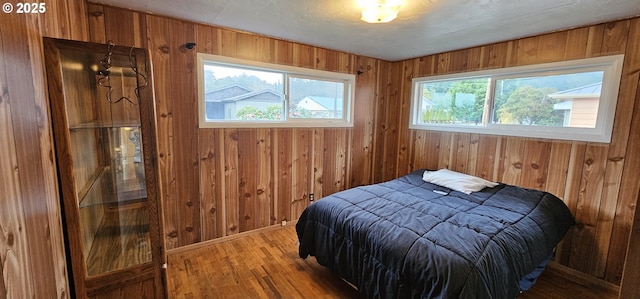 29545 Bailor St, Gold Beach, OR 97444 - bedroom with wood walls and light wood-style flooring
