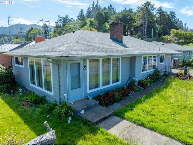 29545 Bailor St, Gold Beach, OR 97444 - view of front facade featuring a chimney, a front lawn, and a shingled roof