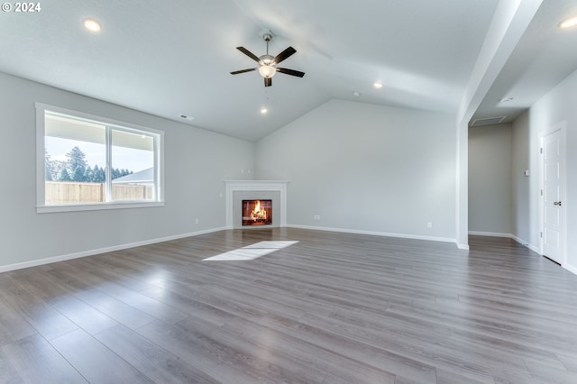 unfurnished living room featuring lofted ceiling, light wood-type flooring, and ceiling fan