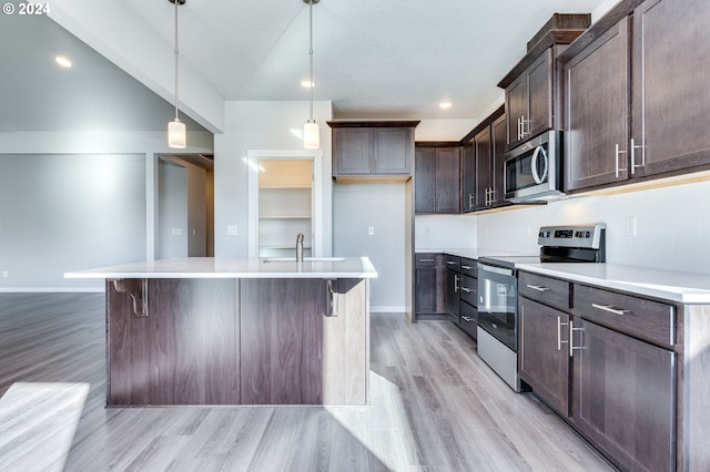 kitchen featuring a kitchen island with sink, light hardwood / wood-style flooring, hanging light fixtures, dark brown cabinets, and appliances with stainless steel finishes