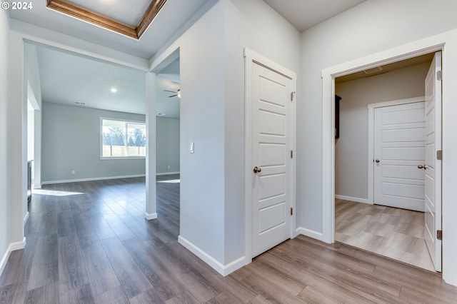 corridor with wood-type flooring