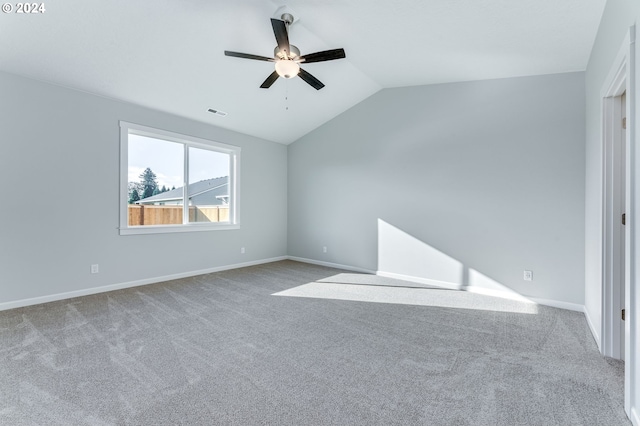 unfurnished room with ceiling fan, light colored carpet, and vaulted ceiling