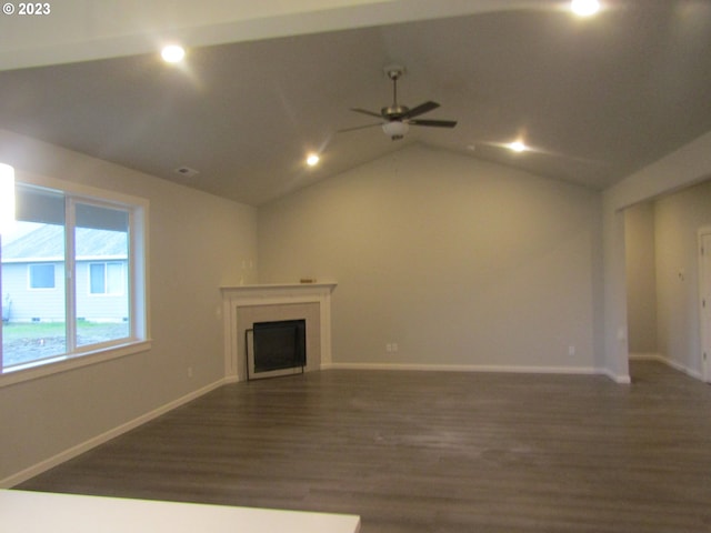 unfurnished living room featuring vaulted ceiling, dark hardwood / wood-style floors, and ceiling fan