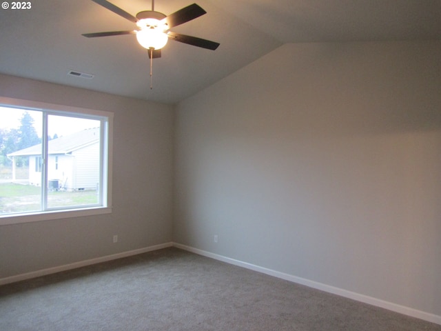 carpeted empty room featuring ceiling fan and vaulted ceiling