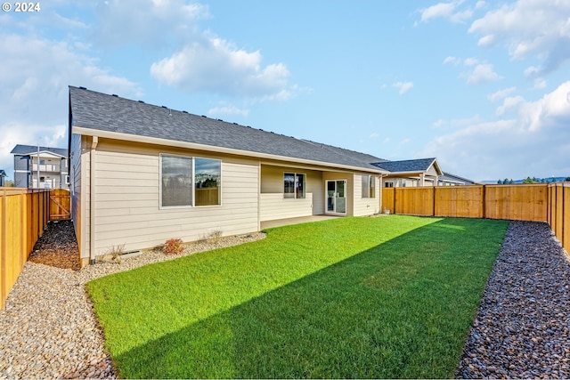 rear view of property with a yard