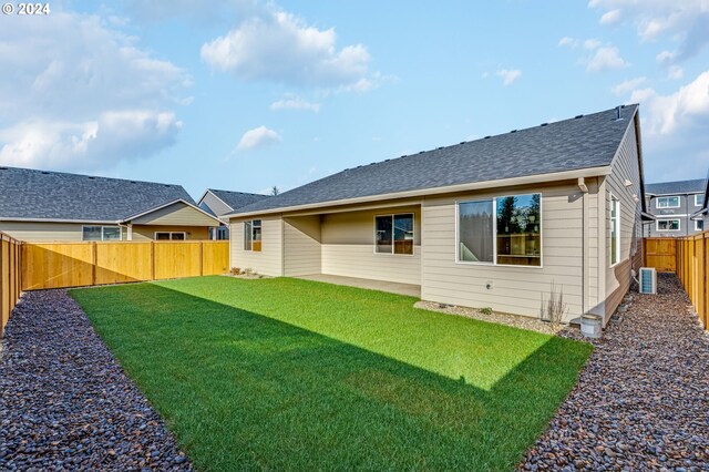 back of house featuring a yard, a patio, and central AC unit