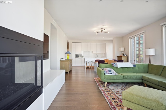 living room with a notable chandelier and hardwood / wood-style flooring