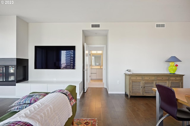 bedroom featuring dark wood-type flooring and connected bathroom