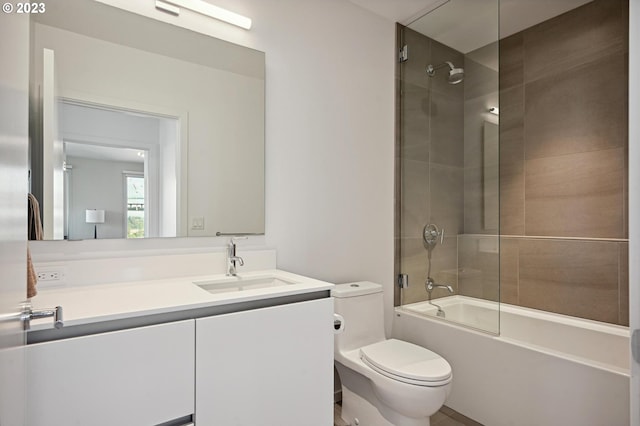 full bathroom featuring toilet, tiled shower / bath combo, and vanity