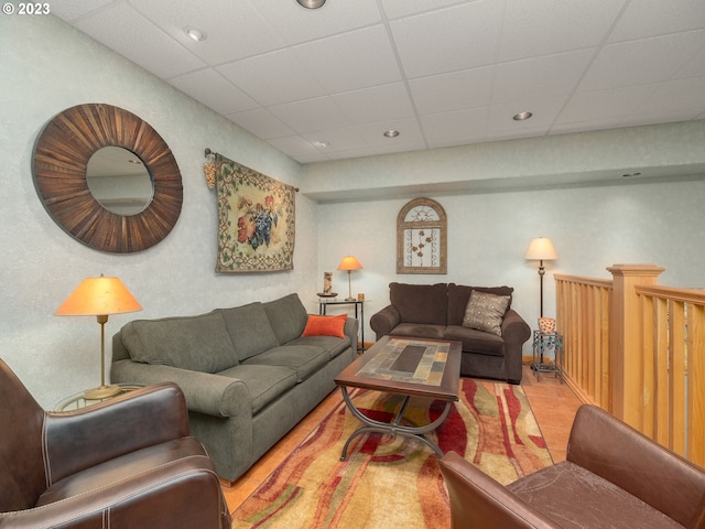 tiled living room with a paneled ceiling