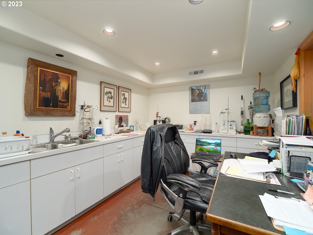 office space featuring sink and a raised ceiling