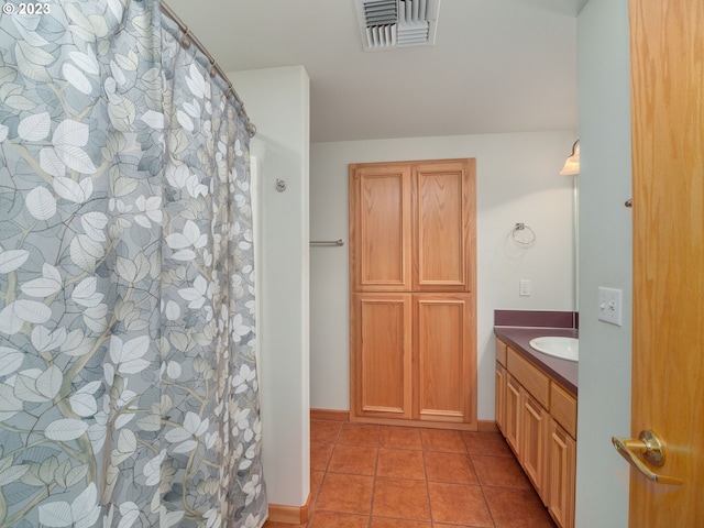 bathroom with tile flooring and vanity