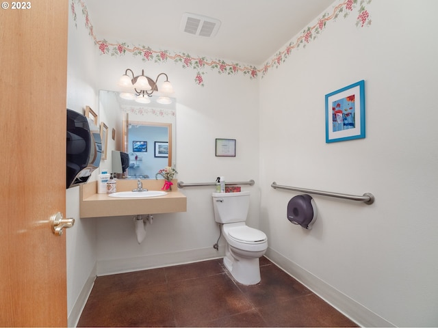 bathroom with toilet, tile floors, and sink