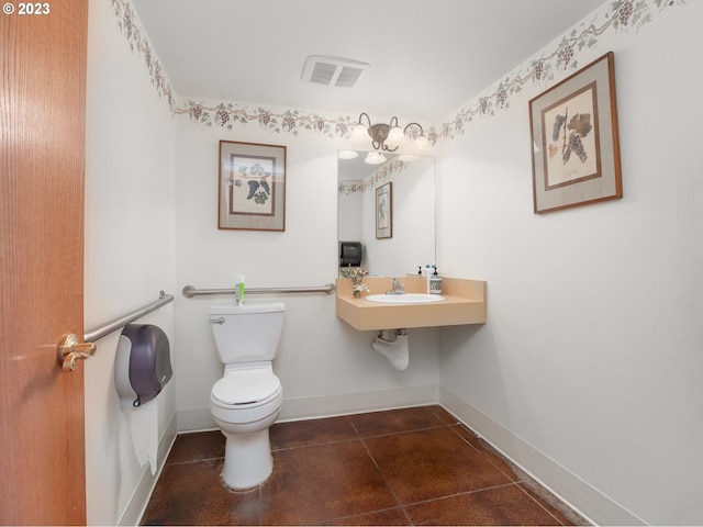 bathroom featuring tile flooring, sink, and toilet