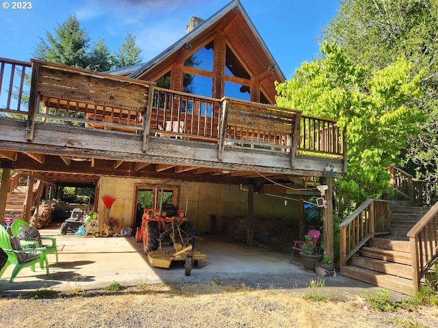 back of house with a deck and a patio area