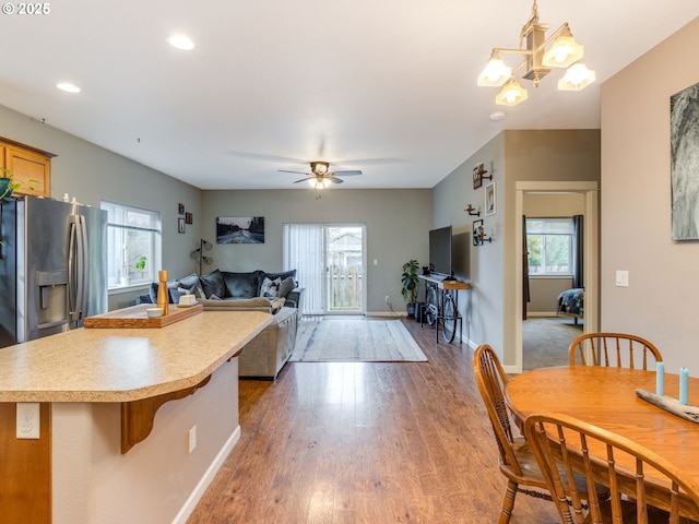 kitchen featuring open floor plan, wood finished floors, stainless steel fridge, and a wealth of natural light