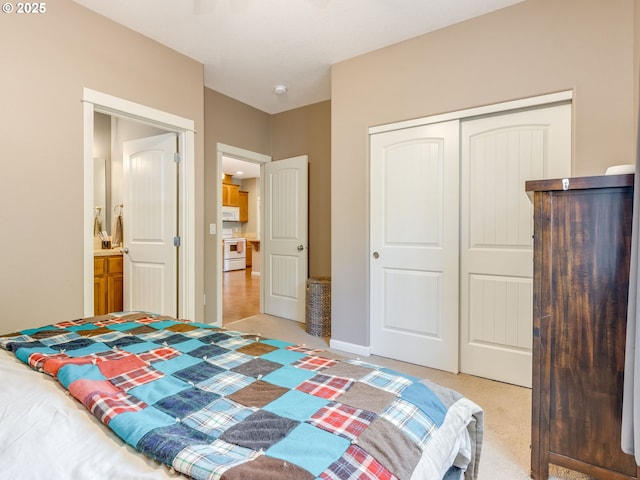 bedroom with light carpet, baseboards, and a closet