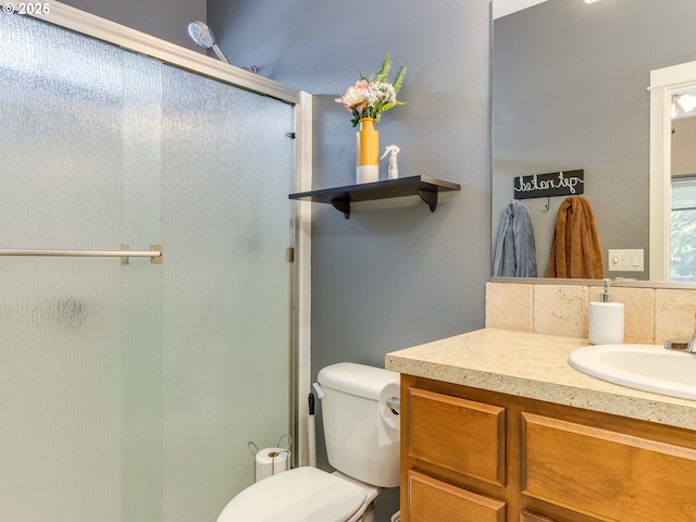 full bathroom featuring vanity, toilet, and an enclosed shower