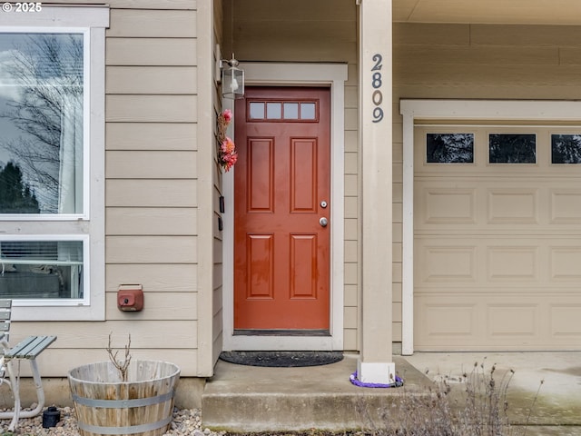 doorway to property with a garage