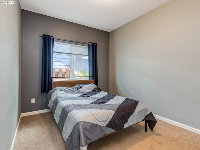 bedroom with carpet flooring and baseboards