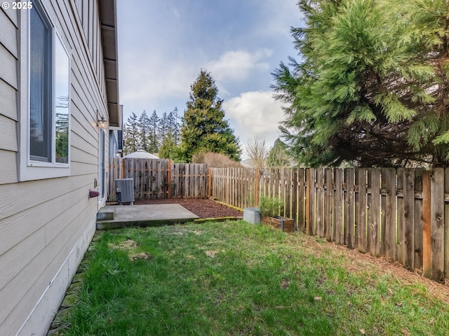 view of yard featuring cooling unit, a fenced backyard, and a patio