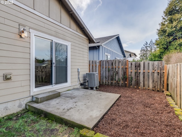 view of patio with a fenced backyard and central air condition unit