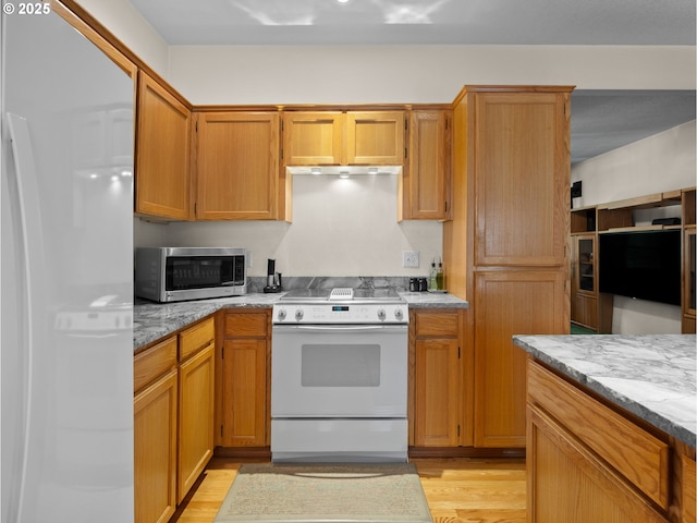 65679 E Alpine Way, Rhododendron, OR 97049 - kitchen featuring light wood-style floors, light stone counters, brown cabinets, and white appliances