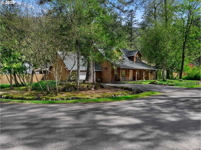 65679 E Alpine Way, Rhododendron, OR 97049 - tudor home with covered porch, metal roof, and aphalt driveway