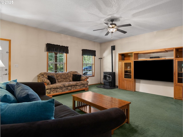 65679 E Alpine Way, Rhododendron, OR 97049 - carpeted living room with a wood stove, a textured ceiling, and a ceiling fan