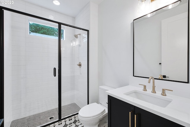 bathroom featuring a shower with door, vanity, and toilet