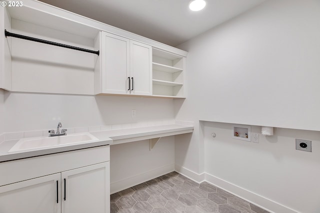 washroom with cabinets, washer hookup, hookup for an electric dryer, sink, and light tile floors