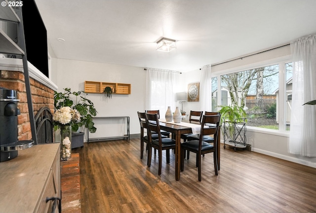 dining space with dark hardwood / wood-style flooring