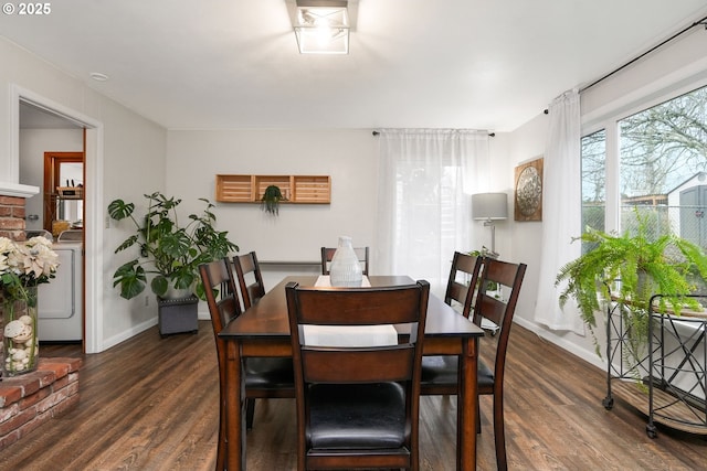 dining room with washer / clothes dryer and dark hardwood / wood-style floors