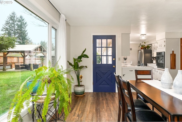 dining area featuring dark wood-type flooring