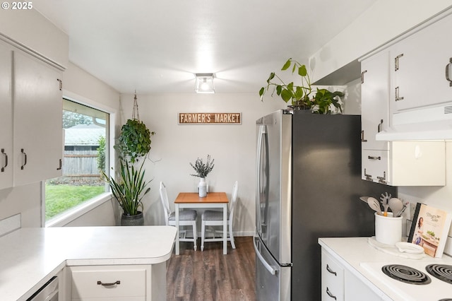 kitchen with white cabinets, dark wood-type flooring, and stainless steel refrigerator