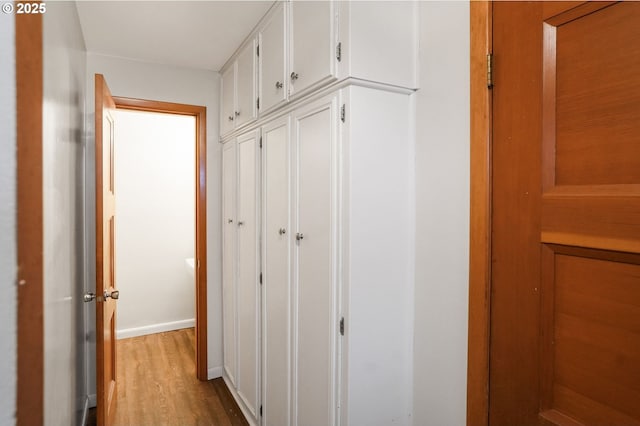 hallway with light hardwood / wood-style flooring