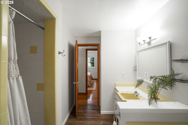 bathroom featuring wood-type flooring, vanity, and curtained shower