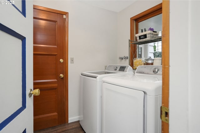 laundry area with washer and dryer and dark hardwood / wood-style flooring