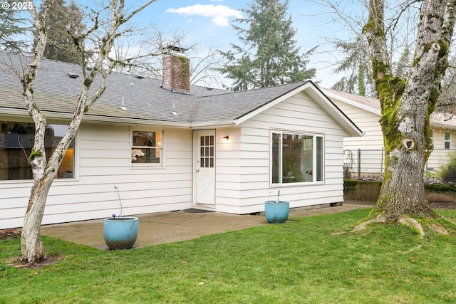 back of house featuring a lawn and a patio