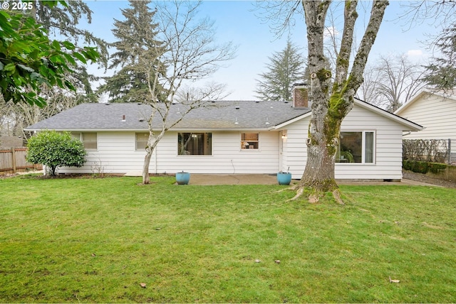 back of house featuring a lawn