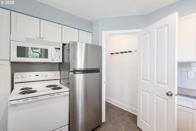 420 S State St, Lake Oswego, OR 97034 - kitchen with white appliances, white cabinetry, and dark tile patterned flooring