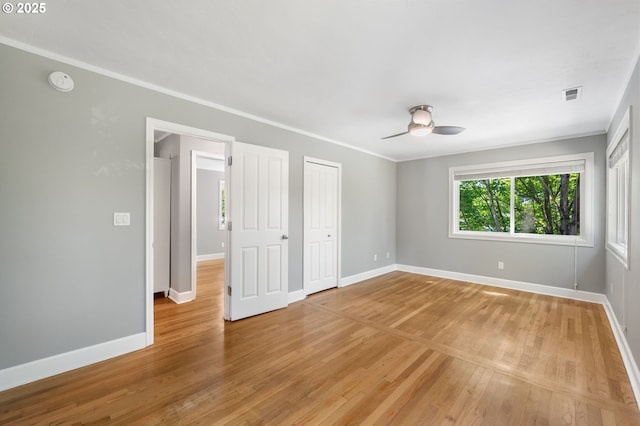420 S State St, Lake Oswego, OR 97034 - unfurnished bedroom featuring light wood-style flooring, ornamental molding, a closet, and a ceiling fan