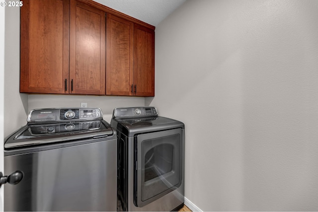 3707 NE Minnehaha St, Vancouver, WA 98661 - washroom featuring baseboards, cabinet space, and washer and clothes dryer