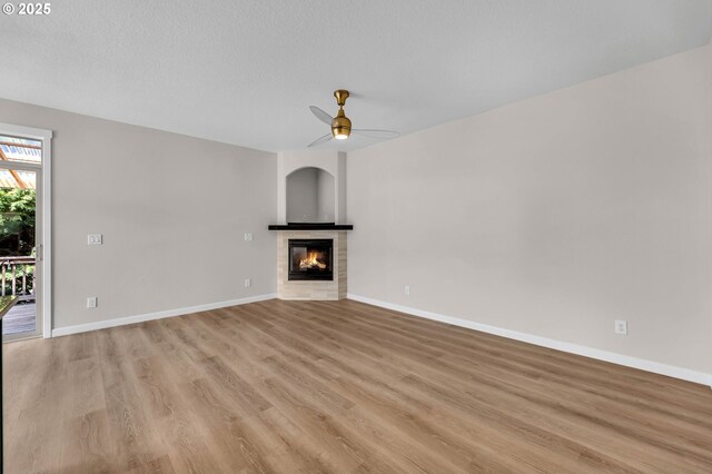 3707 NE Minnehaha St, Vancouver, WA 98661 - unfurnished living room featuring baseboards, a tile fireplace, light wood finished floors, and ceiling fan